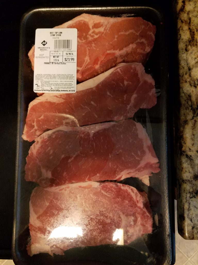 Raw strip steaks before seasoning