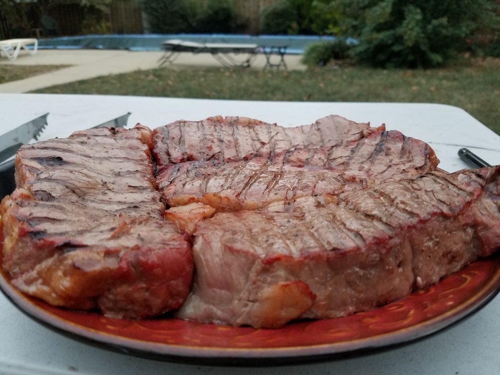 Strip steaks pulled from the smoker at 122 degrees