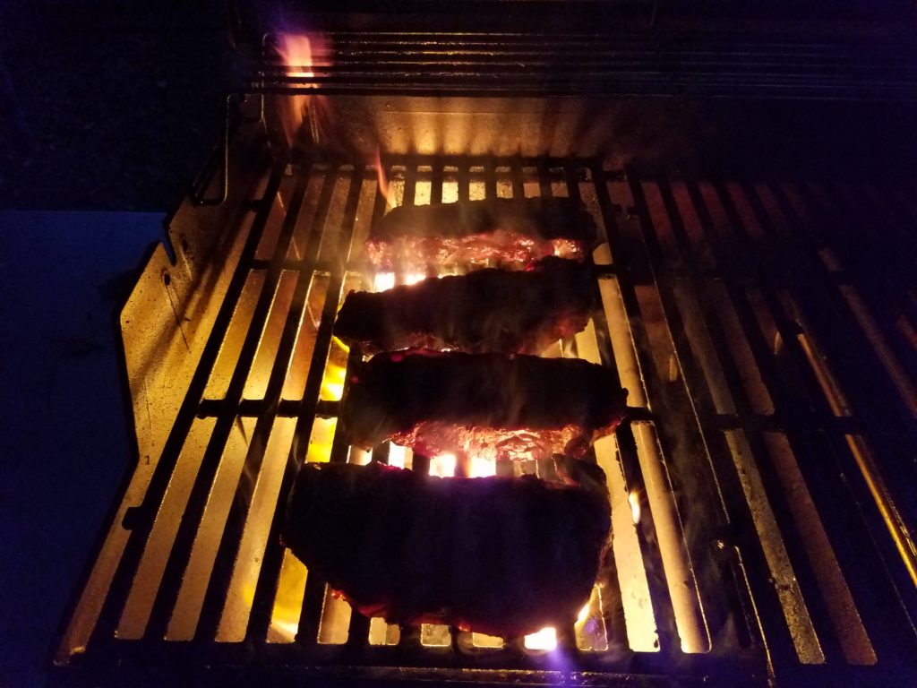 Strip steaks searing on a 600 degree propane grill