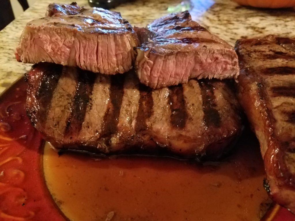 Finished reverse seared strip steaks, showing center cut