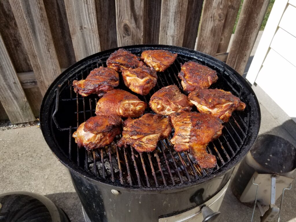 Chicken thighs on the smoker with cherry wood