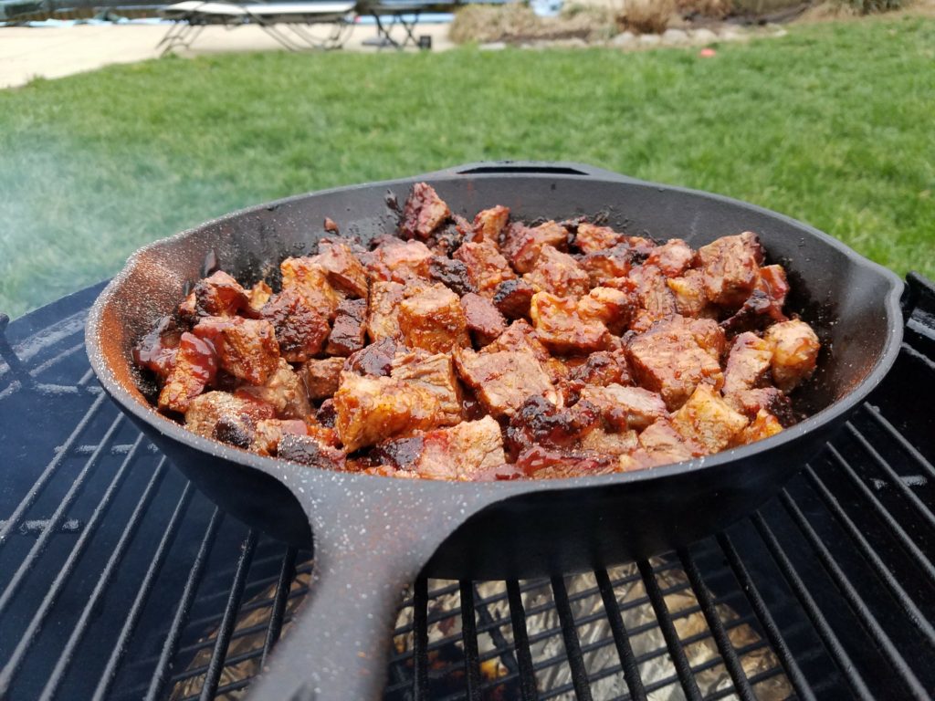 Cubed brisket back on the smoker with barbecue sauce