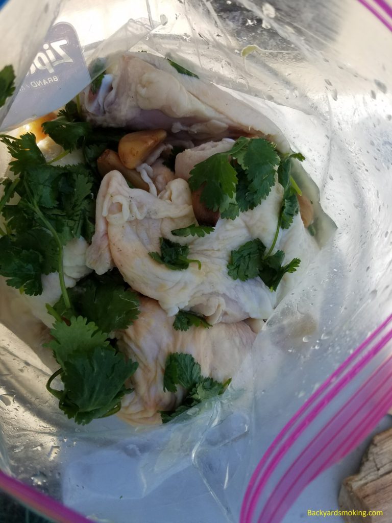 Chicken thighs marinating in tequila, margarita mix, smoked garlic, and cilantro