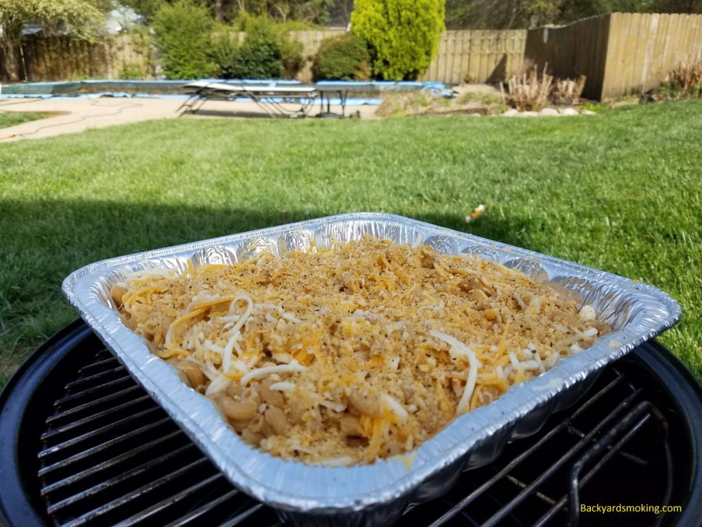 Smoked mac and cheese in a foil pan, going onto the 14-inch smoker