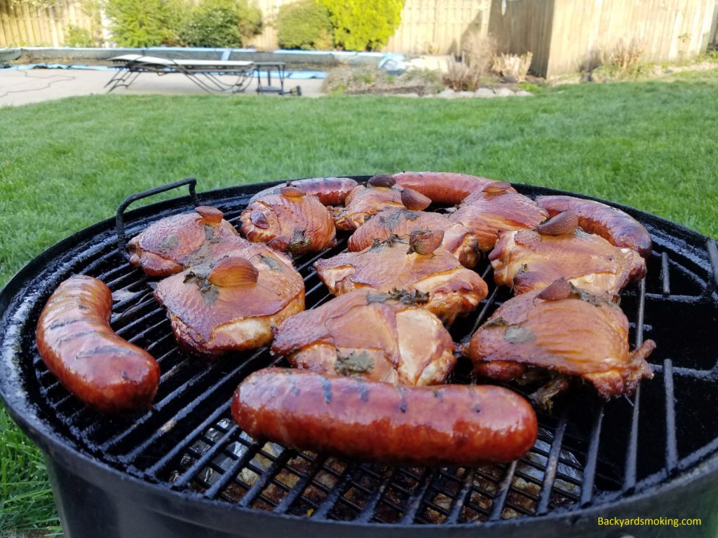 Chicken and sausages coming off the smoker