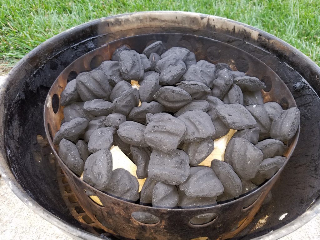 Charcoal ring loaded with briquettes in the smoker