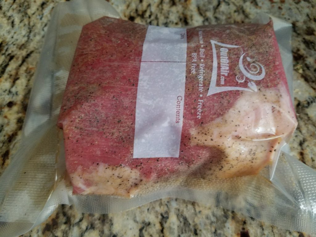 Raw eye round seasoned and bagged for sous vide
