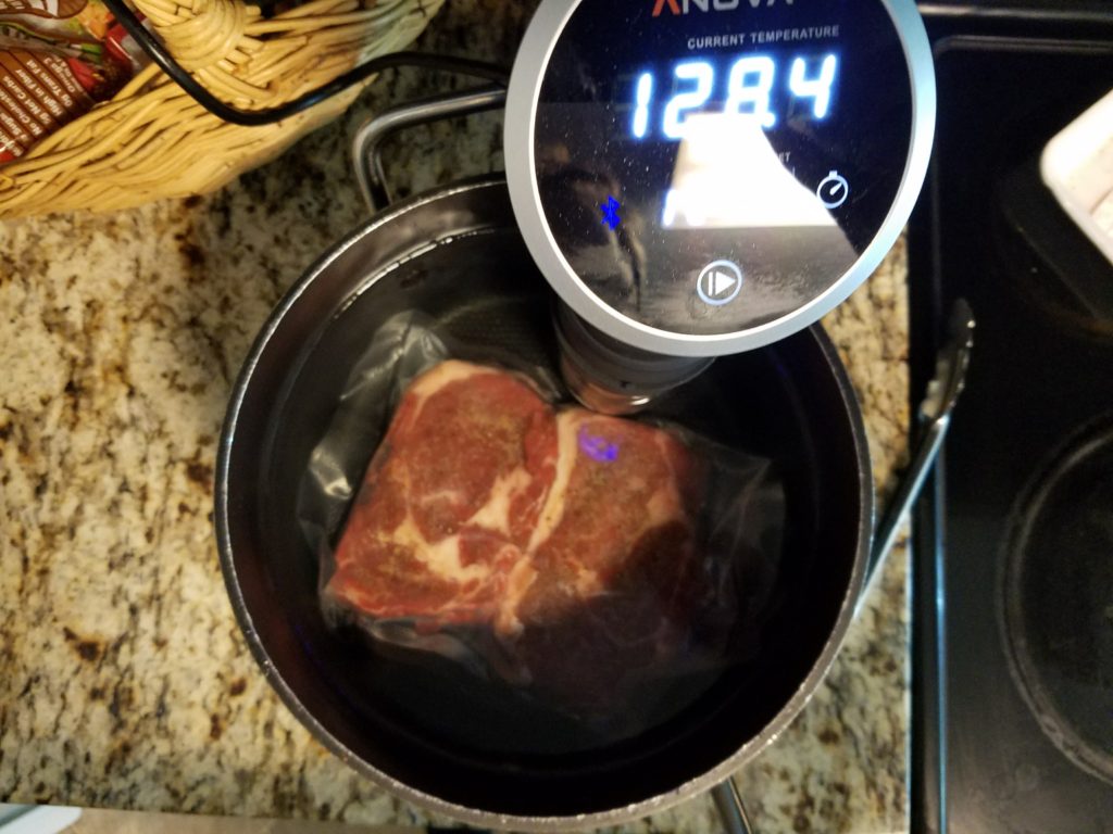 Ribeyes cooking in the sous vide bath