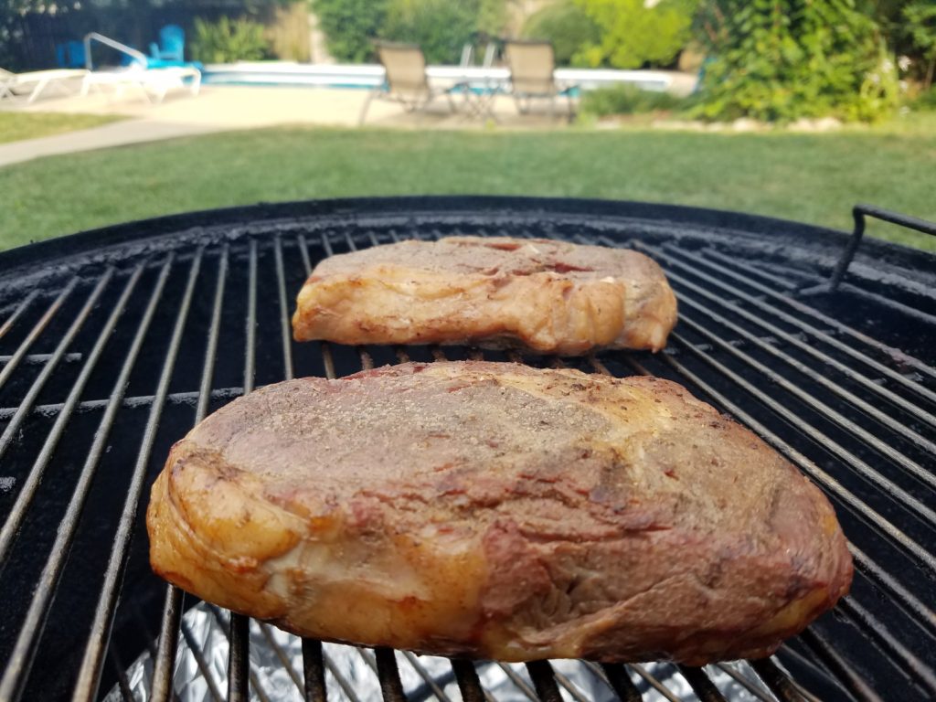 Ribeyes on the smoker with hickory