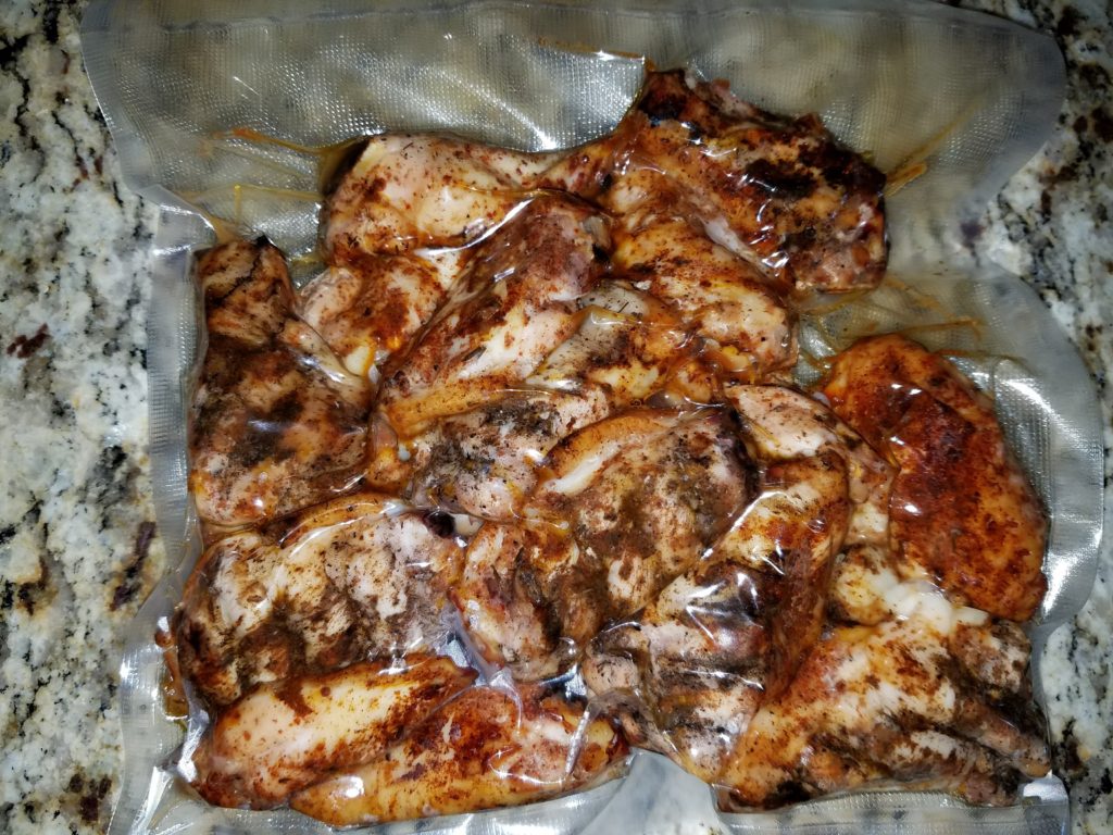 Smoked and seasoned Batch B wings going into the sous vide bath alongside Batch A