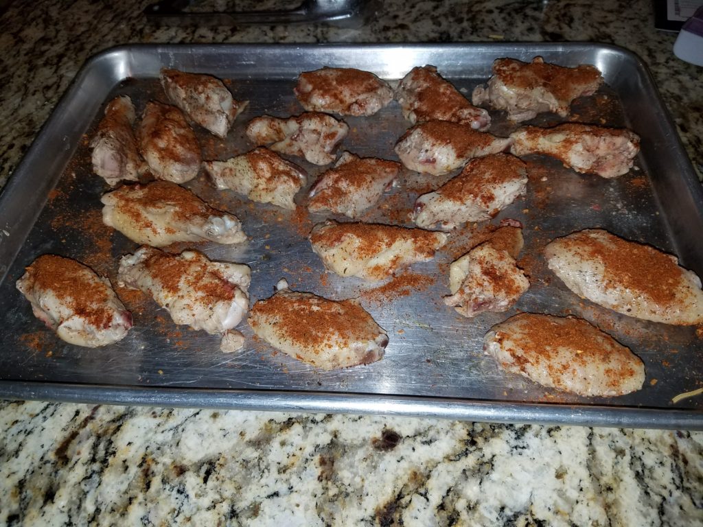 Batch A wings, drained and rubbed, on the tray before their smoker session