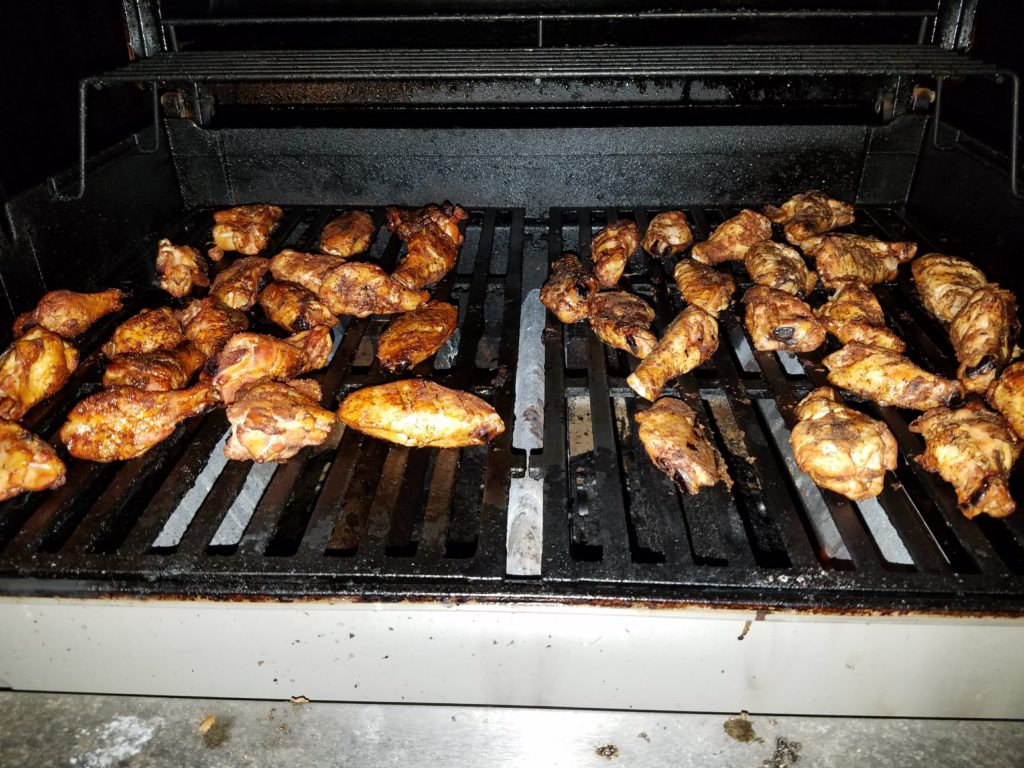 Both batches of wings, kept separate, crisping on the hot propane grill