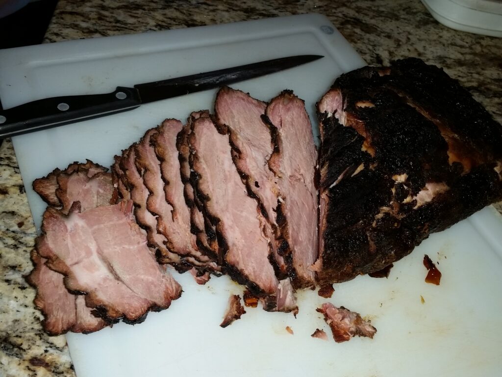 Sliced smoked pork butt on a cutting board