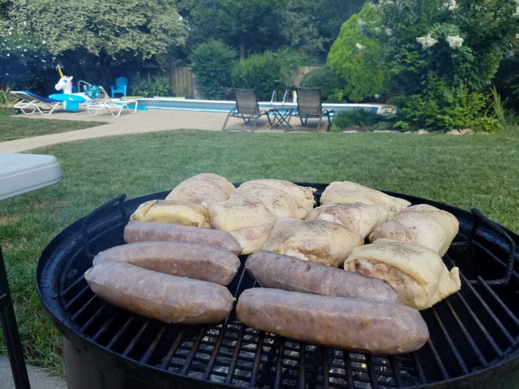 Chicken and sausage on the smoker with cherry wood, right after the sous vide bath