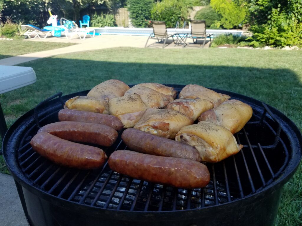 Chicken and sausage taking on color as the smoke progresses