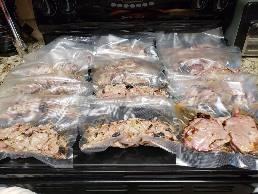 Vacuum-sealed bags of smoked pork laid out in rows